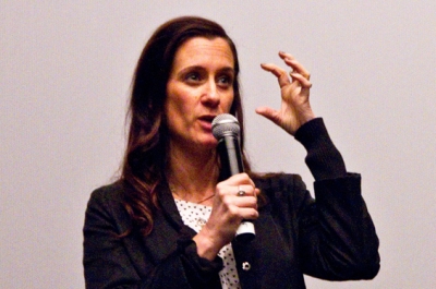 A woman speaking into a microphone