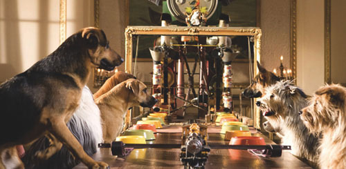 A still image from the film of the dogs all sat round the dinner table being served by one of the inventions