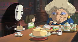 Animated image of an old woman, a little girl and a masked figure sit at a dinner table