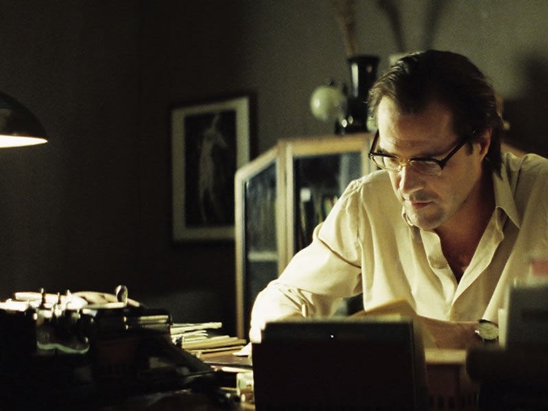 Still from the film, showing Georg Dreyman sat at his desk, writing