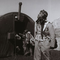 Pilot scanning the skies with parachute room in background