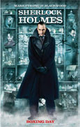 In the centre of the poster we see a mid-shot of a dark haired, white skinned man of domineering appearance. His head is angled slightly downwards whilst his dark hooded eyes look directly at the camera. He wears a thick black coat of leather and fur, with a high asymmetrical collar. His hands, just visible, are crossed in front of him at the waist and he wears black leather gloves. The inky green and black background suggests a London skyline and text reads MARK STRONG BLACKWOOD DEPRAVED ADVERSARY CHRISTMAS DAY